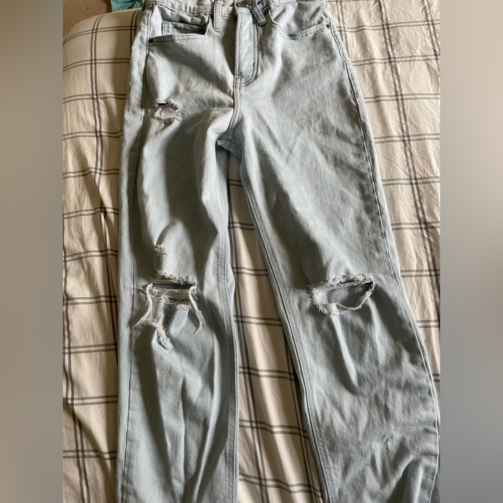 Light washed, high rise, button-fly, ripped jeans